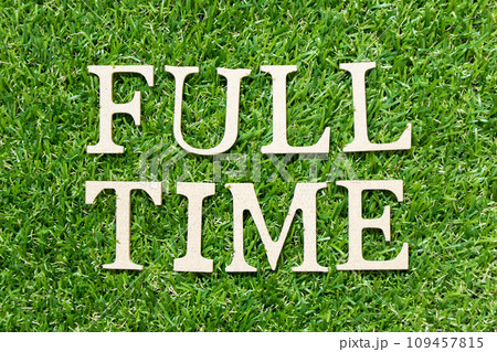 Wood letter in word full time on green grass background Wood letter in word full time on green grass background 109457815