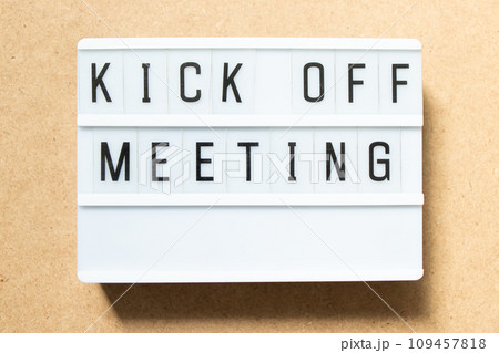 Lightbox with word kick off meeting on wood background 109457818