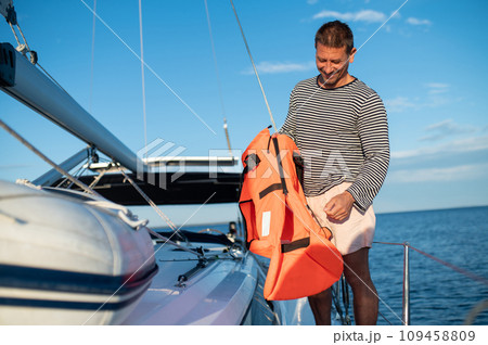 Man on a yacht smiling and feeling peaceful Man on a yacht smiling and feeling peaceful 109458809