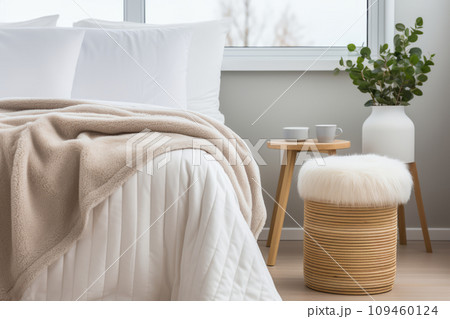 Neutral Scandi-style interior with hygge furniture in the bedroom. Linen bed or bedding. Close up interior details photo. Flowers in a vase for interior decoration. Neutral Scandi-style interior with hygge furniture in the bedroom. Linen bed or bedding. Close up interior details photo. Flowers in a vase for interior decoration. 109460124