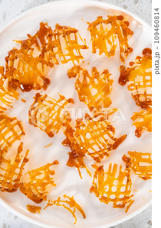 Crunchy caramel cupcake toppers on the counter. 109460814