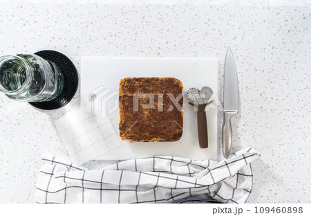 Flat lay. Scoring chocolate peanut butter fudge for cutting into small pieces. 109460898