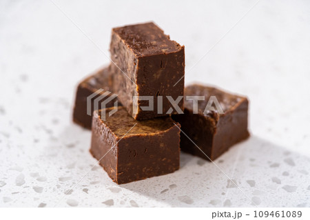 Homemade chocolate peanut butter fudge pieces on the kitchen counter. 109461089