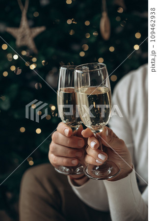 A man and a woman are holding glasses of champagne. Christmas, New year. 109462938