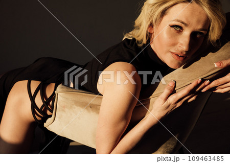 Beautiful blonde woman in black bodycon evening dress 109463485