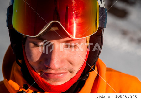 cheerful skier with his eyes closed, stands and smiles. Happy man enjoying holiday in winter season cheerful skier with his eyes closed, stands and smiles. Happy man enjoying holiday in winter season 109463840