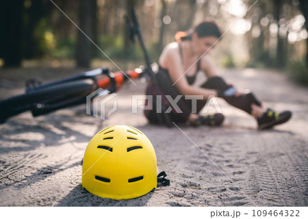 Protective helmet on forest road, bike accident 109464322