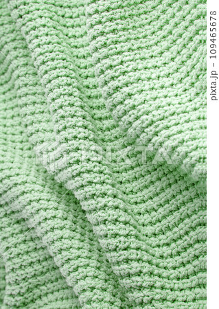 Turquoise green blanket in a large coarse knit with folds. Backdrop for design Turquoise green blanket in a large coarse knit with folds. Backdrop for design 109465678