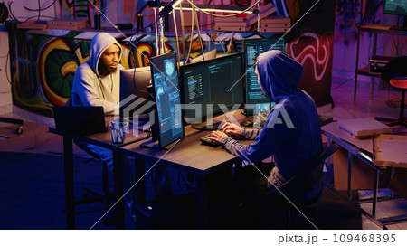 Hackers rushing to leave underground base after hearing police sirens while pirating software. Rogue programmers running to escape law enforcement coming to arrest them for cracking videogames 109468395