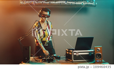 DJ performer presents i dont know symbol on stage, acting clueless and uncertain about answer. Young funky artist being confused and unsure about mixed tunes, shrugging. Tripod shot. 109468435