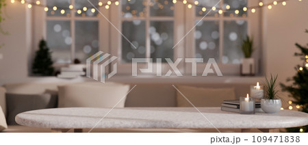 Empty mockup space on a white marble coffee table in a modern, cosy festive living room on Christmas Empty mockup space on a white marble coffee table in a modern, cosy festive living room on Christmas 109471838