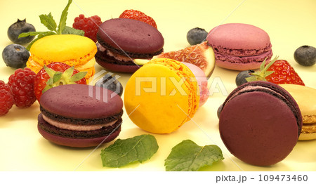 Vibrant scene of table filled with macaroons and fruits Vibrant scene of table filled with macaroons and fruits 109473460