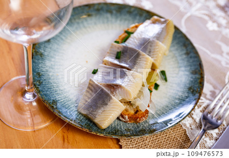 Sandwich with sliced pickled herring fillets and marinated onions Sandwich with sliced pickled herring fillets and marinated onions 109476573