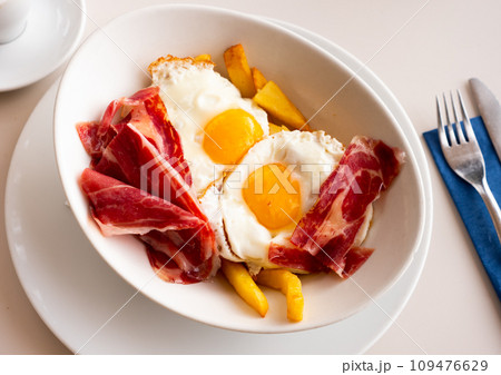 Scrambled eggs with ham and french fries Scrambled eggs with ham and french fries 109476629