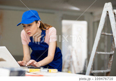 Woman architect using laptop at renovating apartment Woman architect using laptop at renovating apartment 109476710