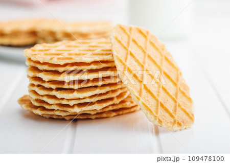 Round waffle biscuits on white table. Round waffle biscuits on white table. 109478100