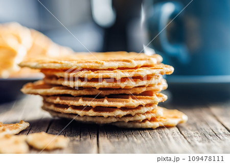 Round waffle biscuits on wooden table. 109478111