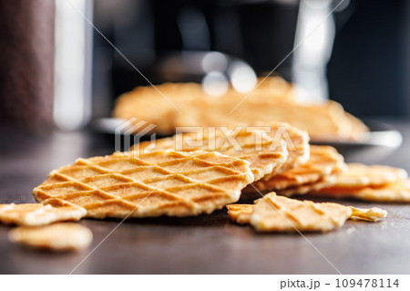 Round waffle biscuits on kitchen table. 109478114