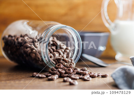 Sweet breakfast cereals in jar on kitchen table. 109478129