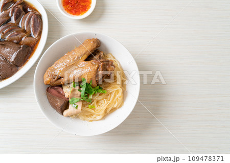 dried noodles with braised duck in white bowl dried noodles with braised duck in white bowl 109478371