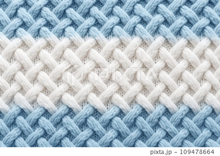Macro photography of the texture of a knitted pattern in close-up, white and blue colors 109478664