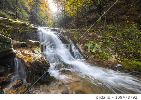 Autumn landscape with waterfall in a beautiful backlight. 109478792