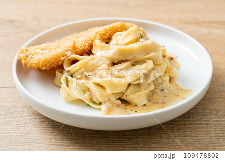 fettuccine pasta white cream sauce with fried fish fettuccine pasta white cream sauce with fried fish 109478802