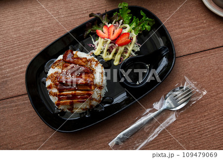 Steamed Jasmine Rice Paired with Fried Pork and Delicious Japanese-Style Dipping Sauce, Served on the Dining Table. 109479069