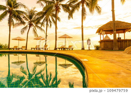 Umbrella and chair around swimming pool in resort hotel for leisure travel and vacation neary sea ocean beach 109479759