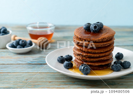 chocolate pancake stack with blueberry and honey chocolate pancake stack with blueberry and honey 109480506