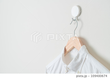 hanging shirt with wood hanger on wall hanging shirt with wood hanger on wall 109480674