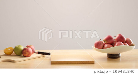 A Bowl of Colorful Fresh Fruits on Wooden Table Next to a Rustic Cutting Board 3d render illustration 109481840