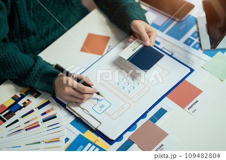 Creative male web designer planning application development for web mobile phone at modern workplace. Creative male web designer planning application development for web mobile phone at modern workplace. 109482804