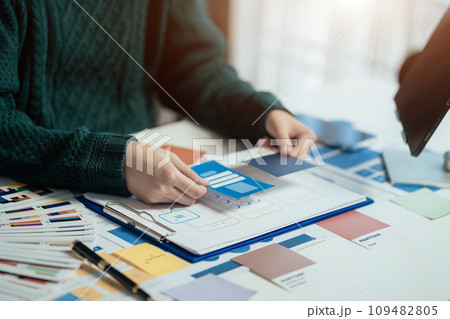 Creative male web designer planning application development for web mobile phone at modern workplace. Creative male web designer planning application development for web mobile phone at modern workplace. 109482805