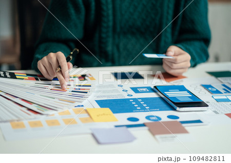 Creative male web designer planning application development for web mobile phone at modern workplace. Creative male web designer planning application development for web mobile phone at modern workplace. 109482811