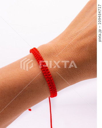 an adult man in a white dress shirt holds a wooden rosary in his hands, without a face close-up 109484717