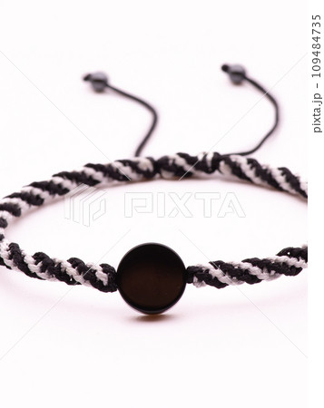 Buddhist bracelet shamballa with gems on a white background Buddhist bracelet shamballa with gems on a white background 109484735