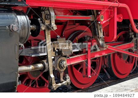 Close-up of red wheels of an old steam train locomotive Close-up of red wheels of an old steam train locomotive 109484927