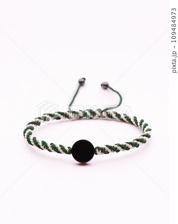 Buddhist bracelet shamballa with gems on a white background 109484973