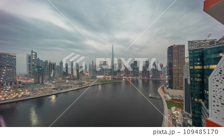Aerial skyline of Dubai Business Bay and Downtown with the various skyscrapers and towers day to night timelapse 109485170