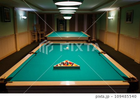 Billiard accessories balls and cue on a billiard table room Billiard accessories balls and cue on a billiard table room 109485540