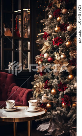 A coffee table with Xmas decor on a background of a sofa and a Christmas tree in the room. 109485925