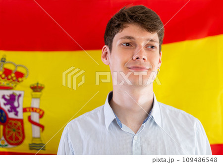 Portrait of positive student against background of flag of Spain 109486548