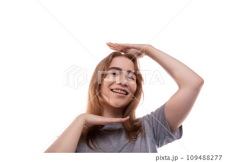 Smiling teenage girl with blond hair in a T-shirt on a white background 109488277