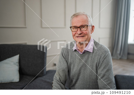 Portrait of confident stylish European middle aged senior man at home. Older mature 70s man smiling. Happy attractive senior grandfather looking camera close up face headshot portrait. Happy people 109491210