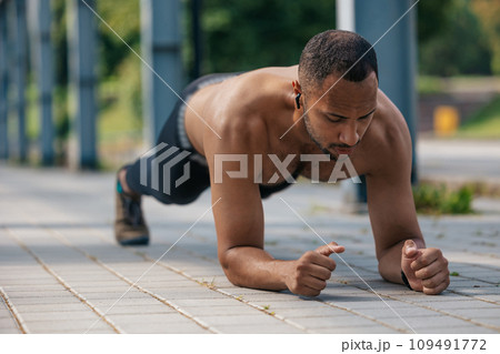 Young well-built african american man standing in plank 109491772