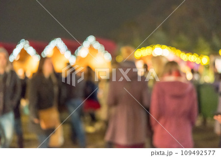 Blurred image bokeh of People walking, shopping at Winter Wonderland, a Christmas Market in Hyde Park, London. 109492577