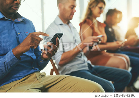 Casual modern business people texting on social media networking applications, on their digital mobile phones. Group of professionals texting on their cellphones together in a row Casual modern business people texting on social media networking applications, on their digital mobile phones. Group of professionals texting on their cellphones together in a row 109494296