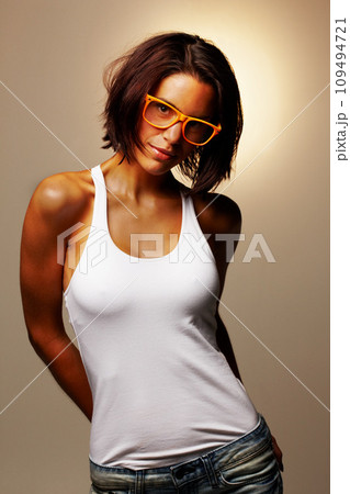 Portrait, woman and fashion with glasses in studio for vision, sight and trendy mock up on brown background. Spain, female model and confidence with pose for cool, modern or hip look with spectacles Portrait, woman and fashion with glasses in studio for vision, sight and trendy mock up on brown background. Spain, female model and confidence with pose for cool, modern or hip look with spectacles 109494721