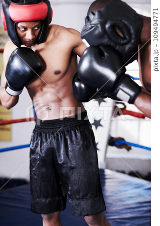 Boxing, man and sparring partner in ring together with headgear, gloves and fitness, power training, challenge. Strong body, fighting hit and boxer in helmet, fearless and confident in competition. Boxing, man and sparring partner in ring together with headgear, gloves and fitness, power training, challenge. Strong body, fighting hit and boxer in helmet, fearless and confident in competition. 109494771